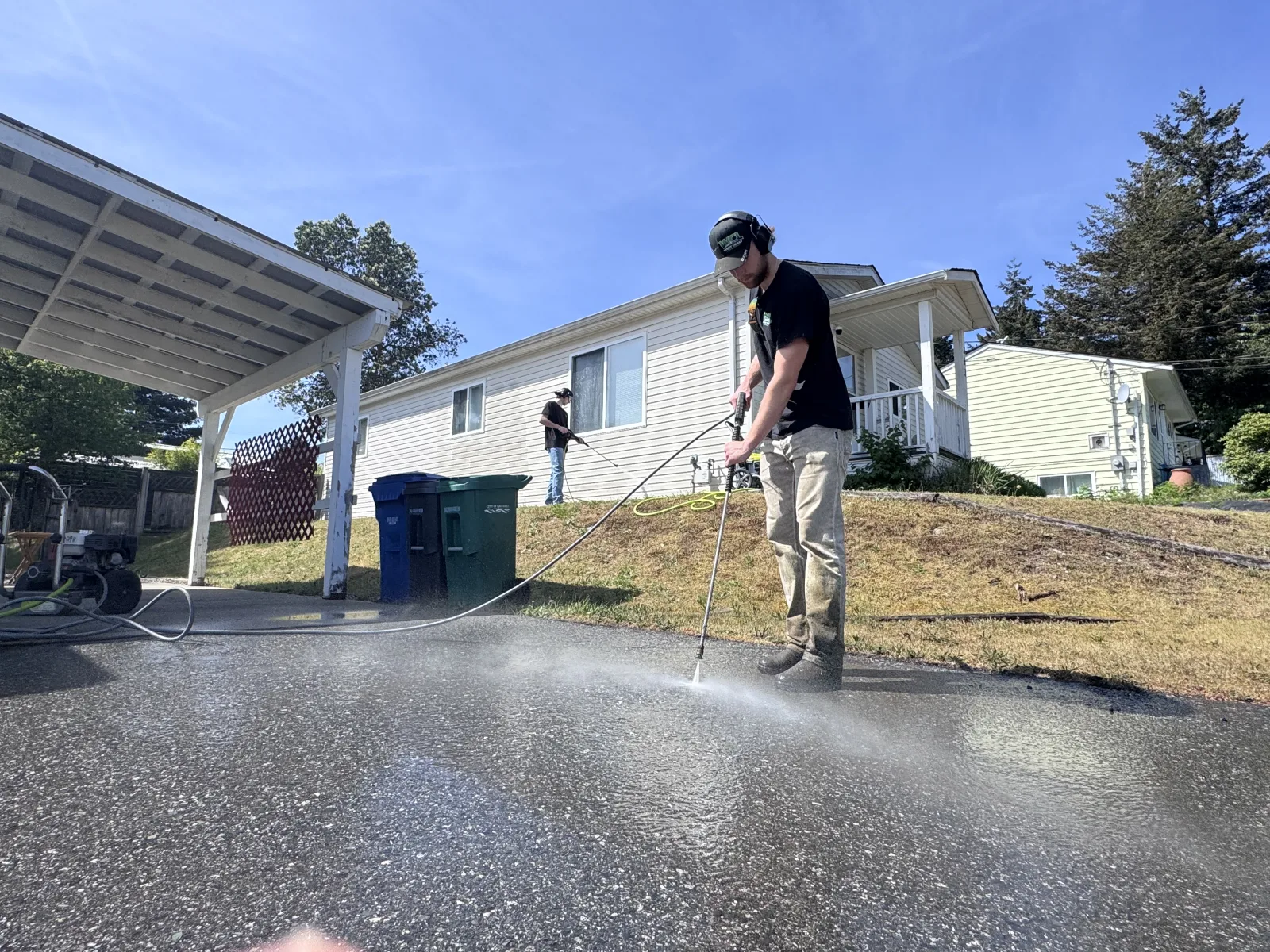 Matthew and Joey pressure-washing a driveway in Nanaimo for a listing-prep job